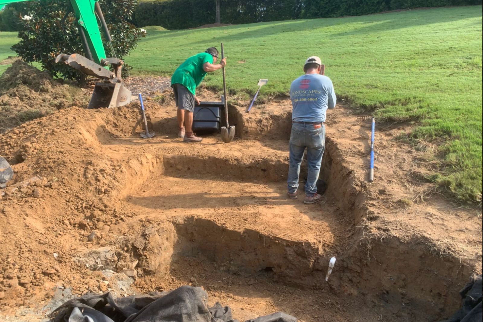 Expert pond building team excavating for waterfalls