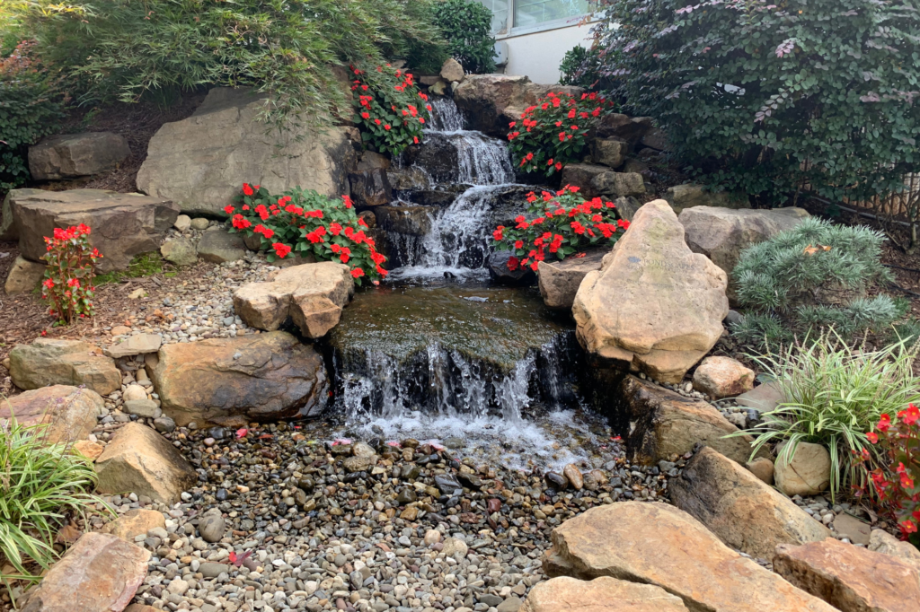 Pondless waterfall with impatiens growing on sides of stream