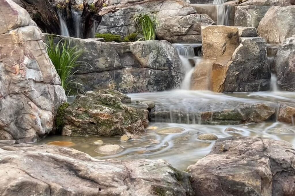 Pondless Waterfall With Mountainscapes by John Deaton