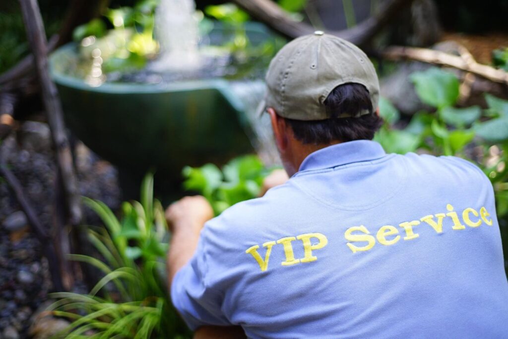 Ken Walls, a Pondscapes of Charlotte VIP Service technician, doing maintenance on a water feature in Charotte, nc