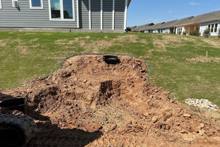 Pond construction in progress with grass removed and an Aquascape 2500 BioFalls installed at the top of the hill in Encore at Streamside, Waxhaw, NC.