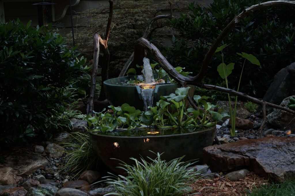 Three Aquascape spillway bowls arranged as a cascading water feature, adding elegance and soothing sounds to an outdoor space.