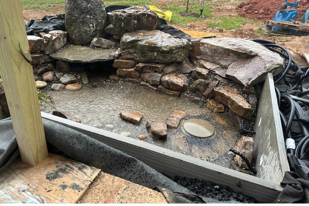 Empty pond under construction by Pondscapes of Charlotte, custom koi pond being built in Wesley Chapel, North Carolina