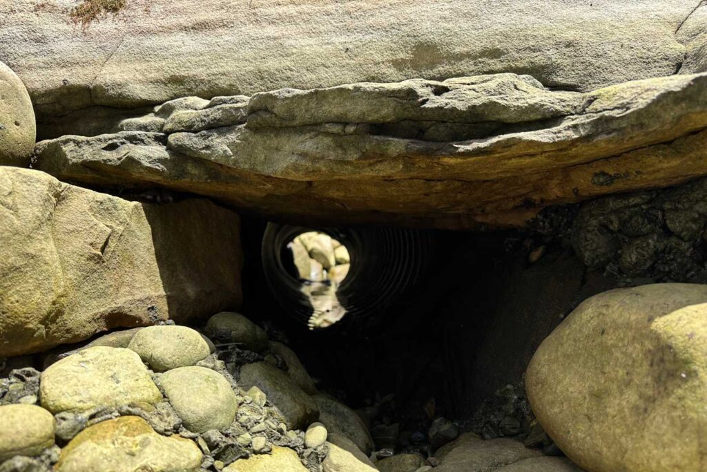 Empty koi tunnel pond under construction by Pondscapes of Charlotte, showing the tunnel structure in Charlotte, North Carolina