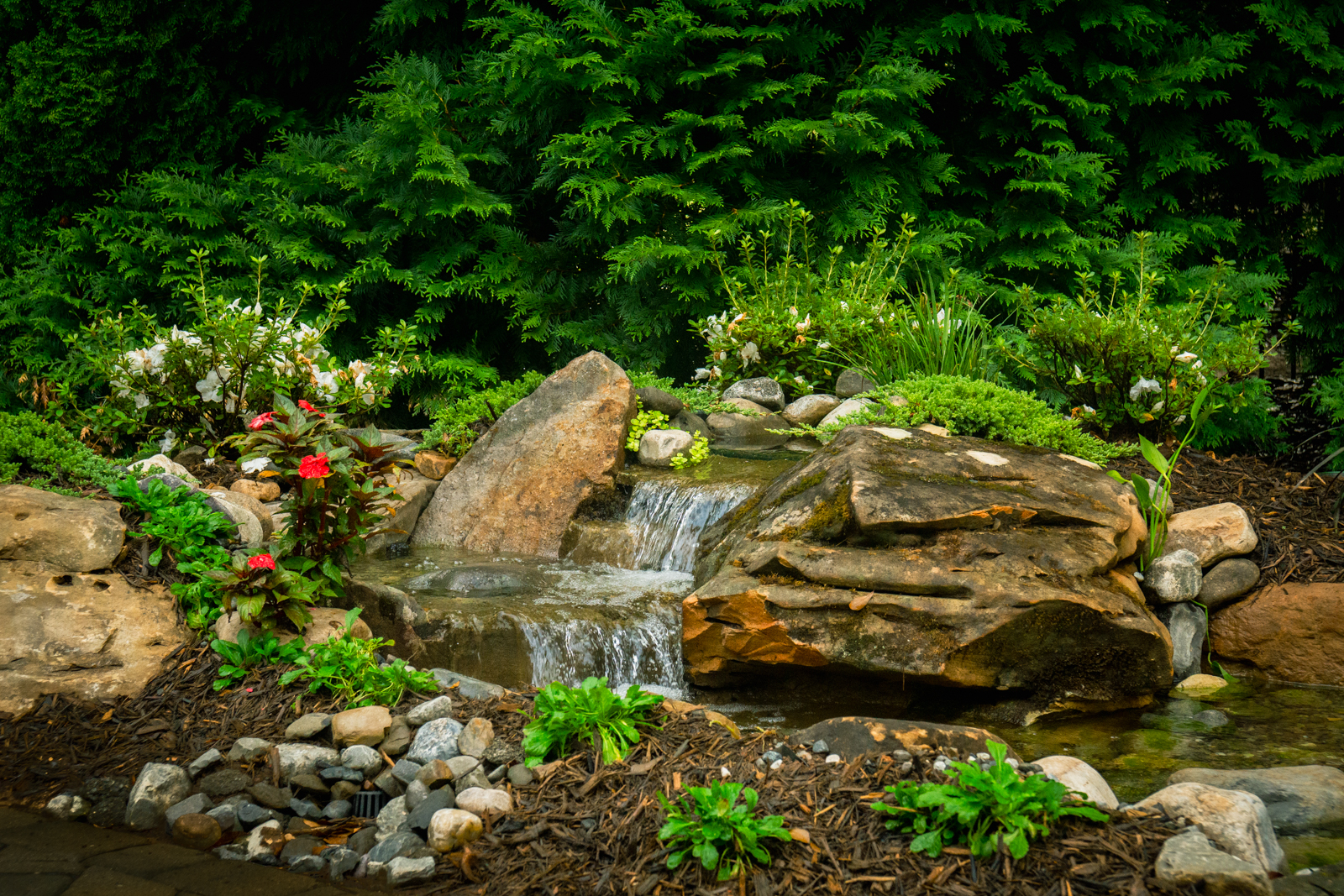 Crystal-clear water cascading over rocks, mimicking a natural mountain stream.