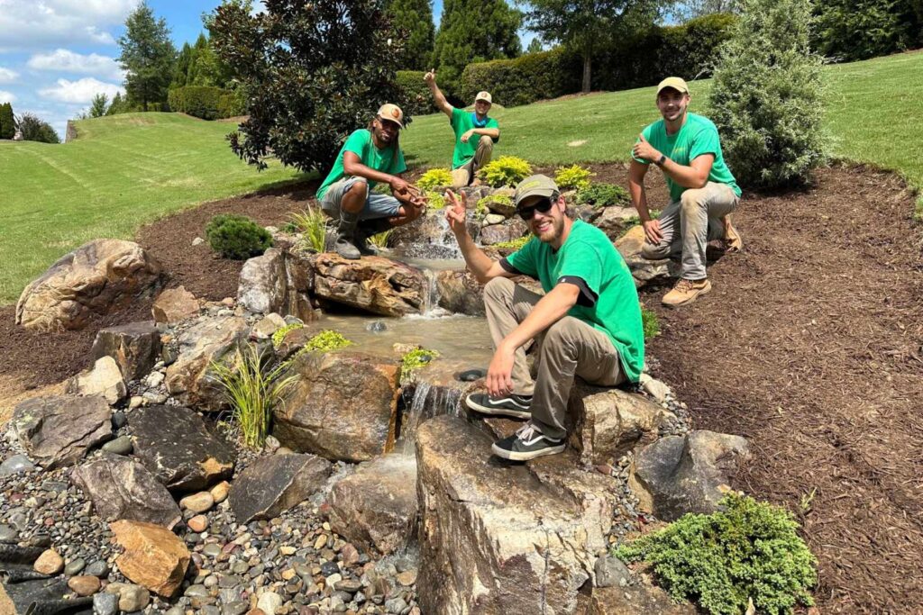 Close-up of an award-winning waterfall feature with natural rocks and flowing water, showcasing expert craftsmanship and serene design.