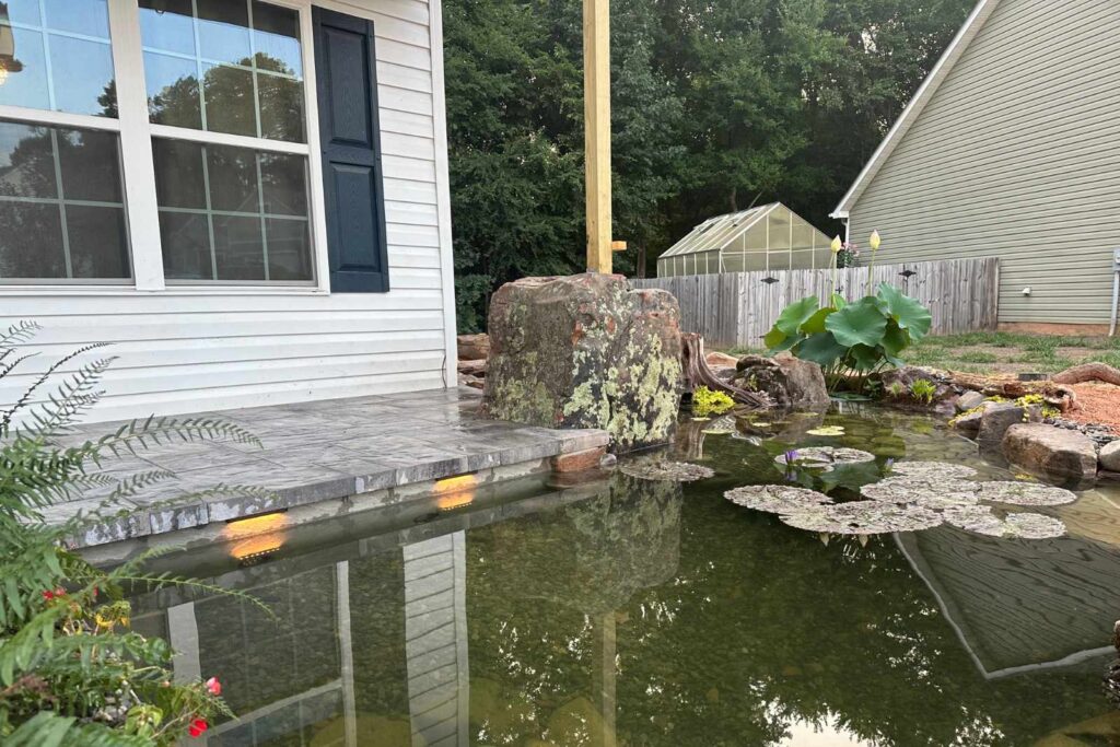 Exposed pond bridge column support during koi pond construction by Pondscapes of Charlotte in Wesley Chapel, North Carolina