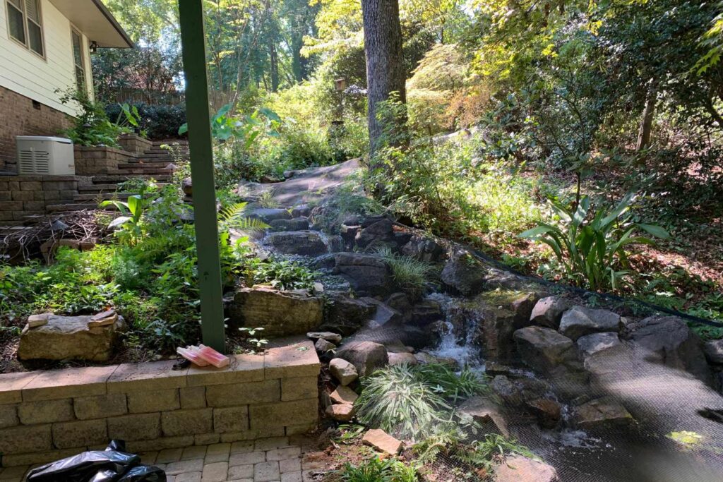 Professional fall pond netting installation in Charlotte NC by Top Frog technician protecting from leaves