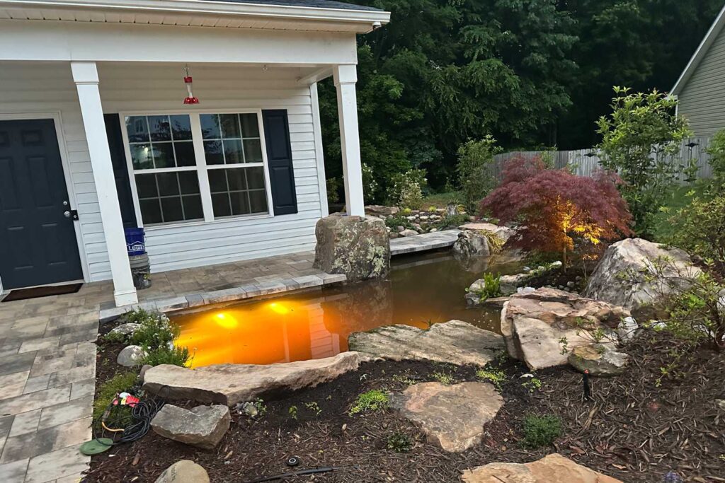 Pondscapes of Charlotte testing underwater pond lights during koi pond construction in Charlotte, North Carolina
