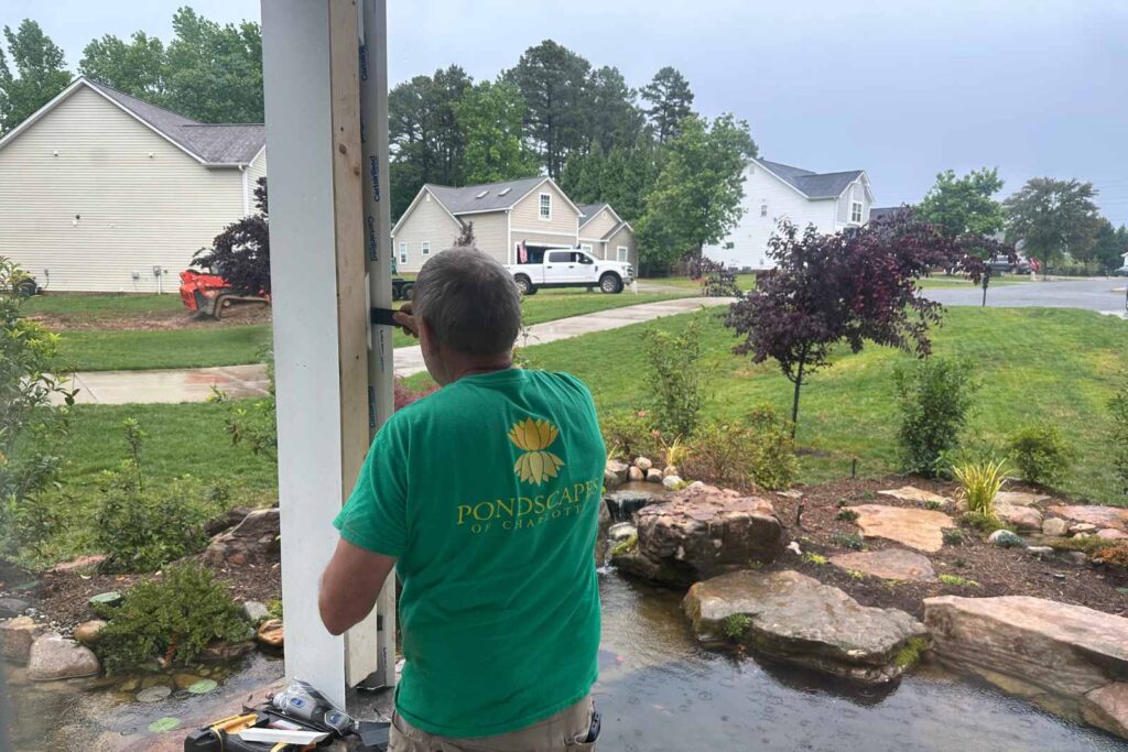Pondscapes of Charlotte crew working on the cover for bridge support during koi pond construction in Wesley Chapel, NC