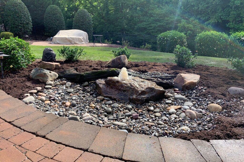 A hand-crafted bubbling boulder water feature designed to enhance outdoor spaces and bring people together.