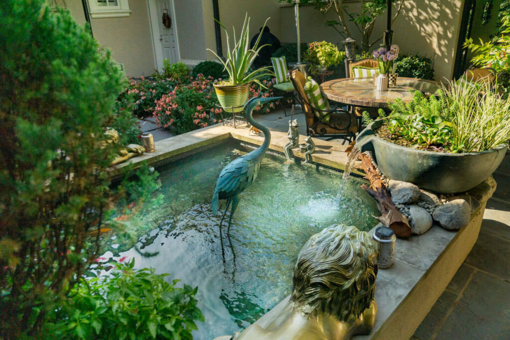 Completed Aquascape spillway bowl installation creating elegant water feature and enhanced filtration for luxury koi pond in South Park, Charlotte