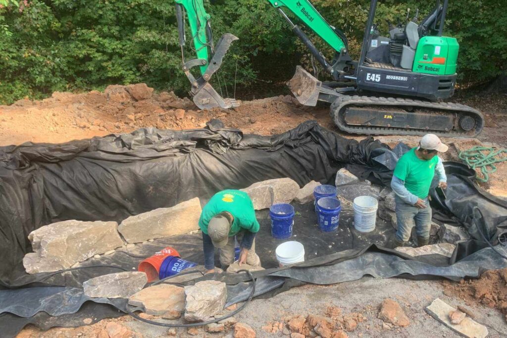 Braeden and Vicente building a pond in Weddington, NC with Pondscapes of Charlotte