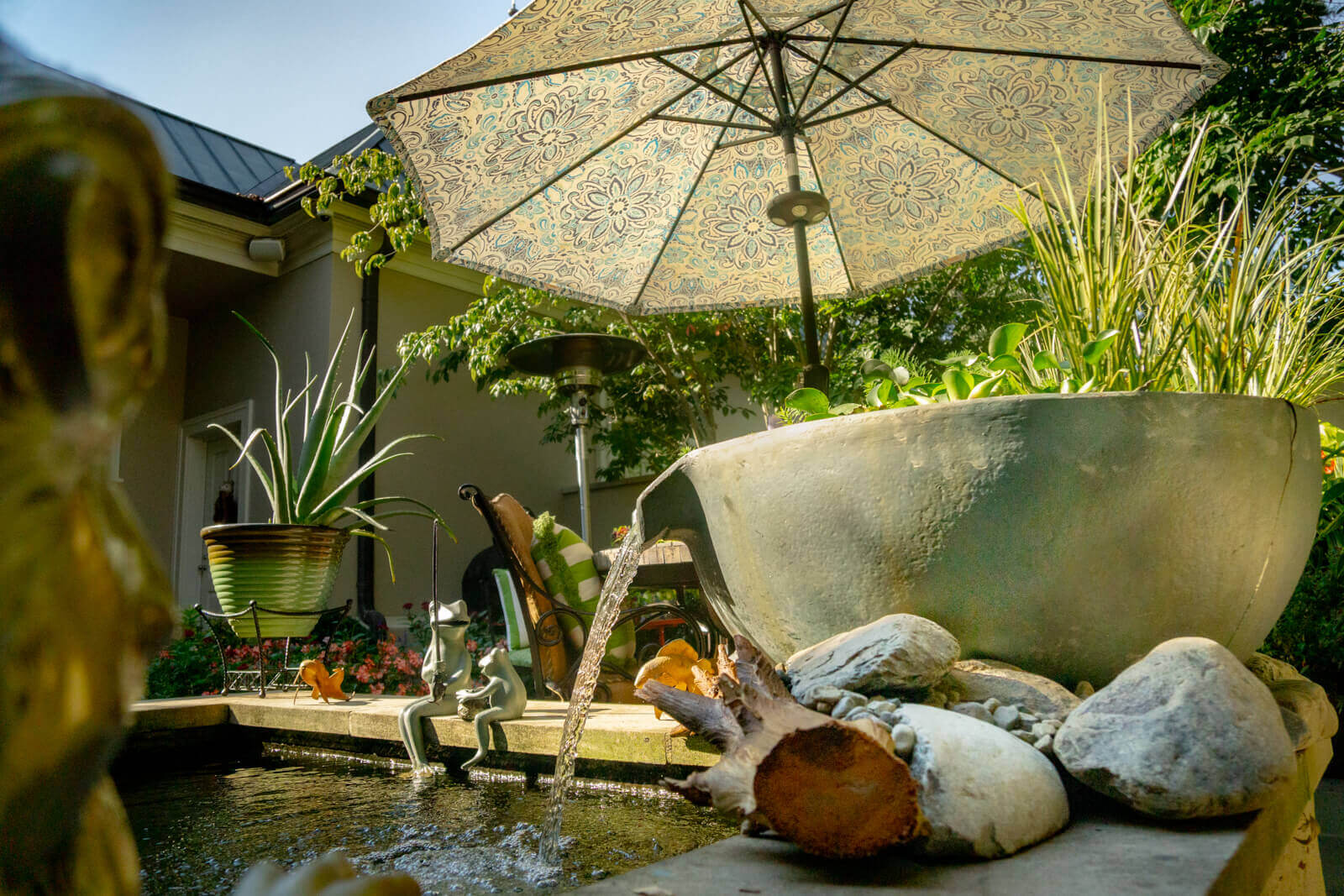 Custom spillway bowl water feature integrated into existing koi pond landscape, in South Park