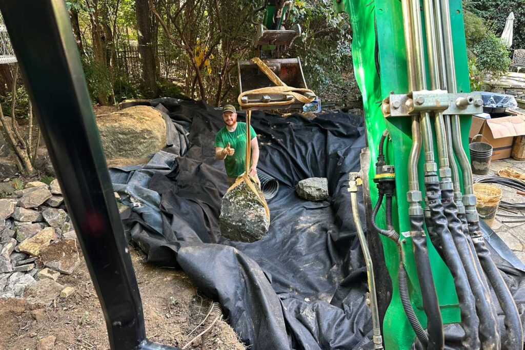 Placing Boulder in pond in South Park