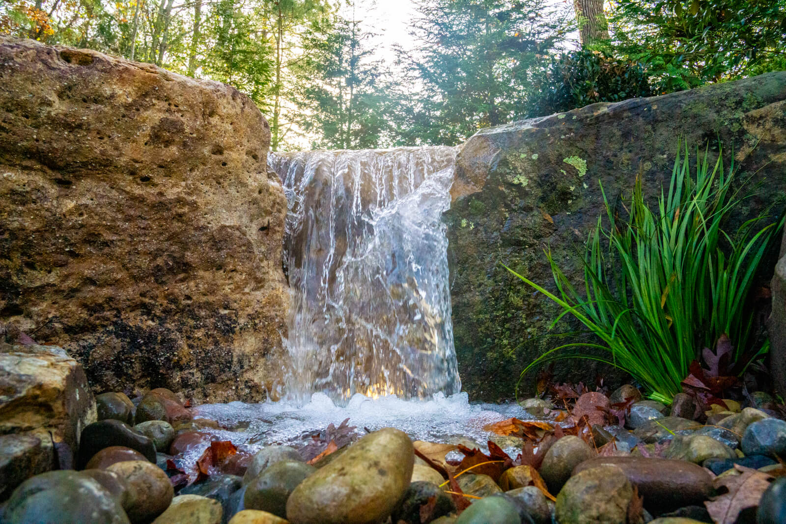 Pondless water feature with natural stone spillway and river rocks Fort Mill SC