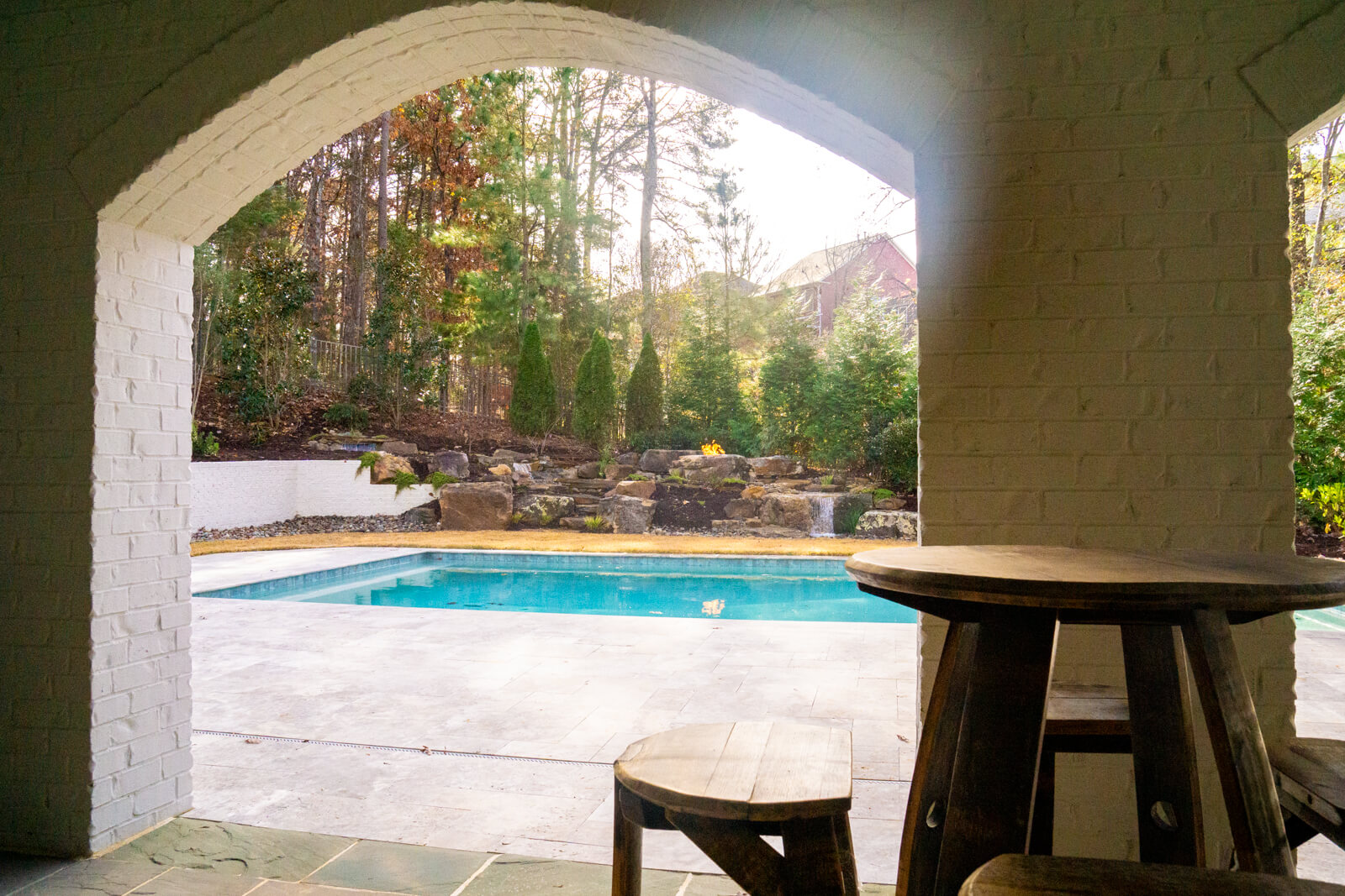 Pool deck view of natural stone waterfall installation Fort Mill SC