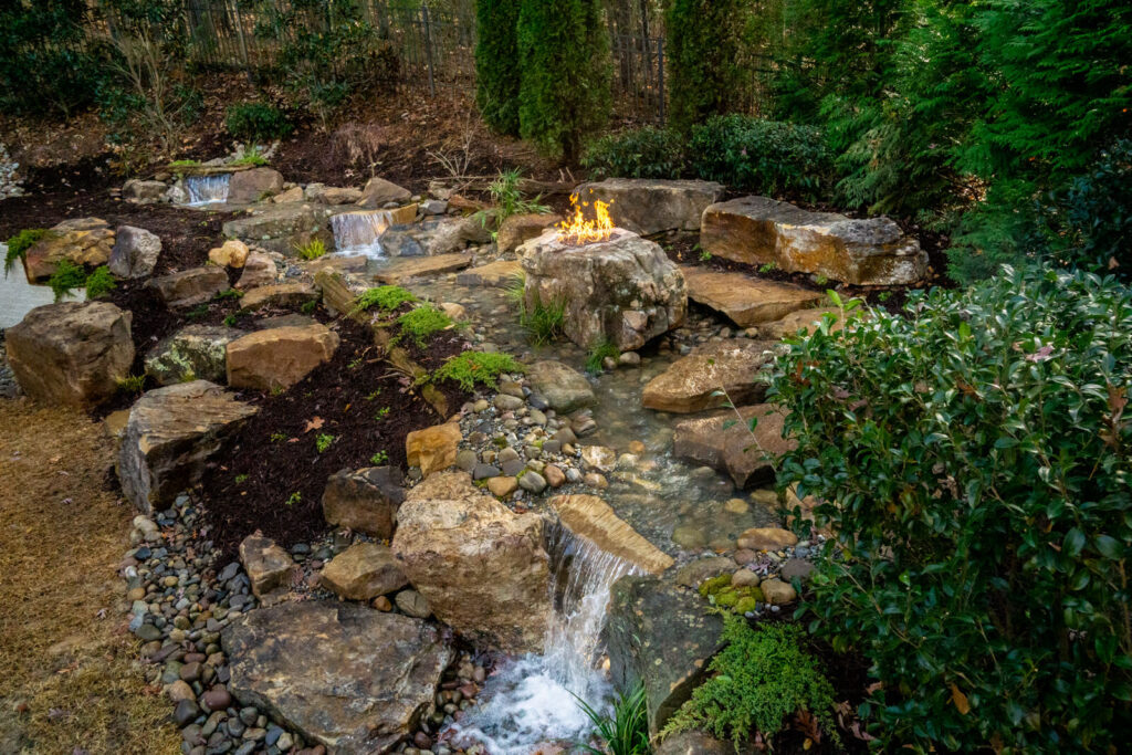 Custom pondless stream with fire pit stone feature Fort Mill SC
