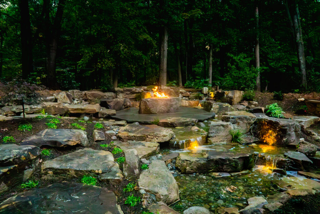 Backyard pondless water feature with flagstone patio and fire pit