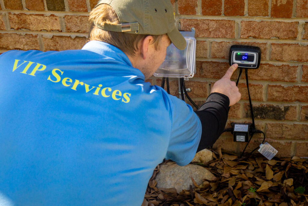 Technician adjusting IonGen system during pond maintenance in Charlotte NC