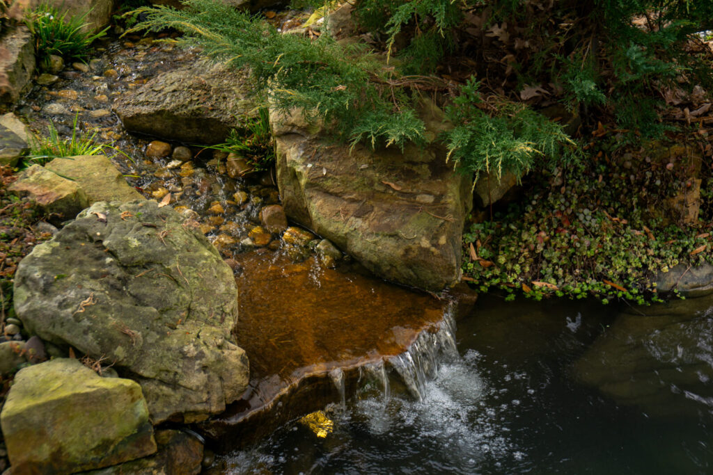 Backyard pond waterfall during winter maintenance visit