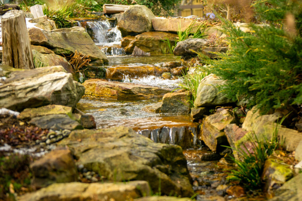 Multi level waterfall during winter pond service in Charlotte