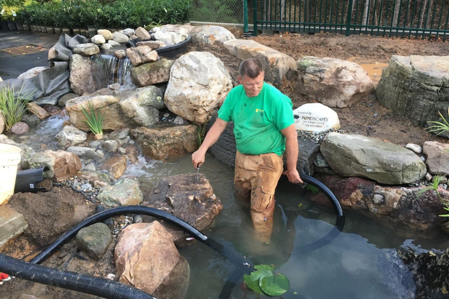 Pondscapes of Charlotte full crew filling and finishing commercial pond installation at Pike Nurseries Matthews NC