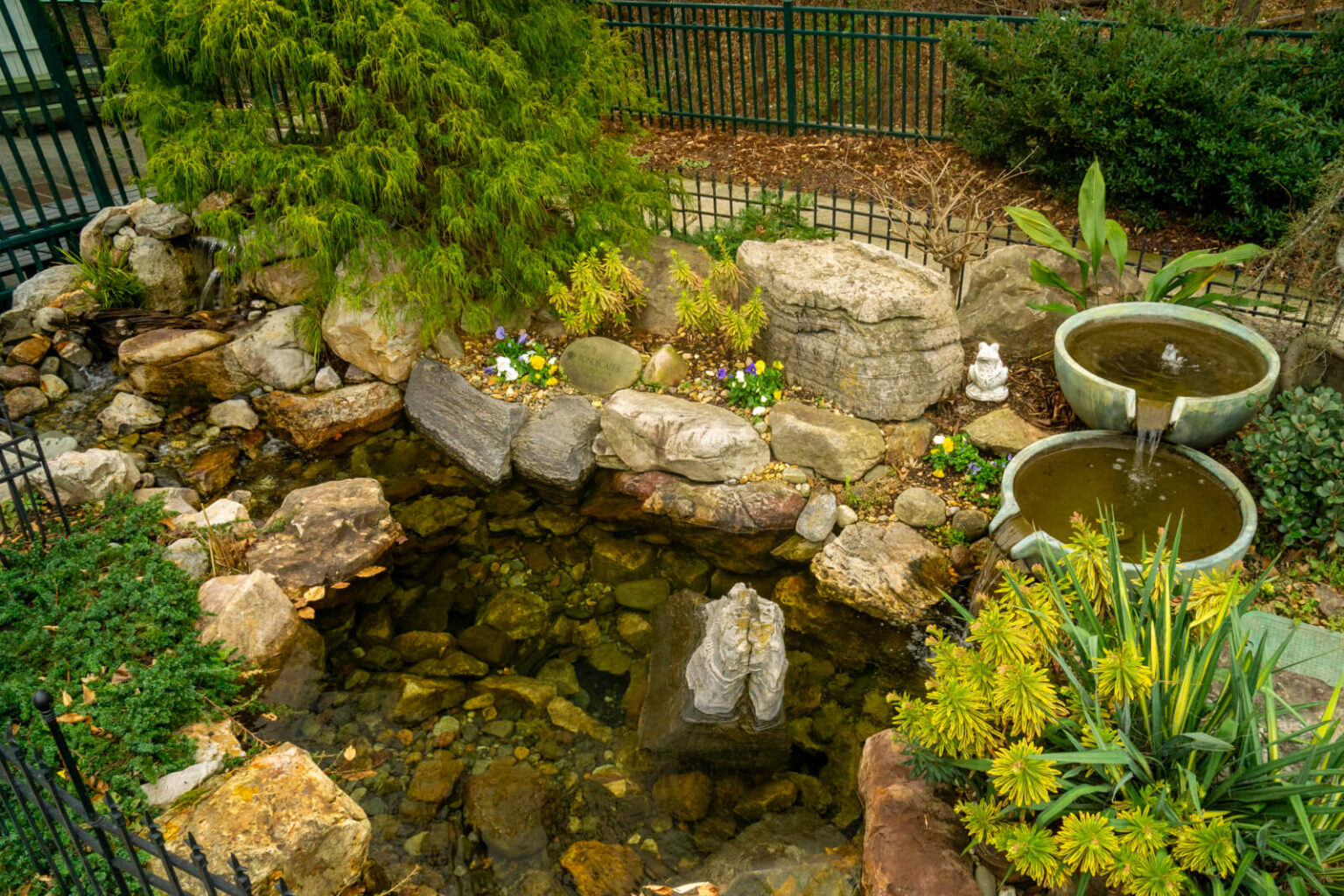 Natural stone pond with an Aquascape spillover bowl fountainscape and waterfall at Pike Nurseries Matthews NC