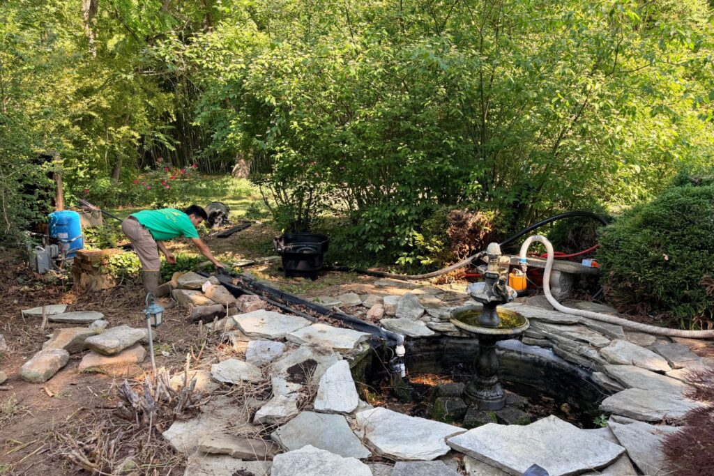 Pondscapes of Charlotte team working on deconstruction of pond