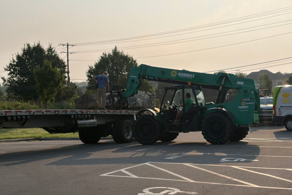 Machinery being delivered on site for new pond feature construction to begin.