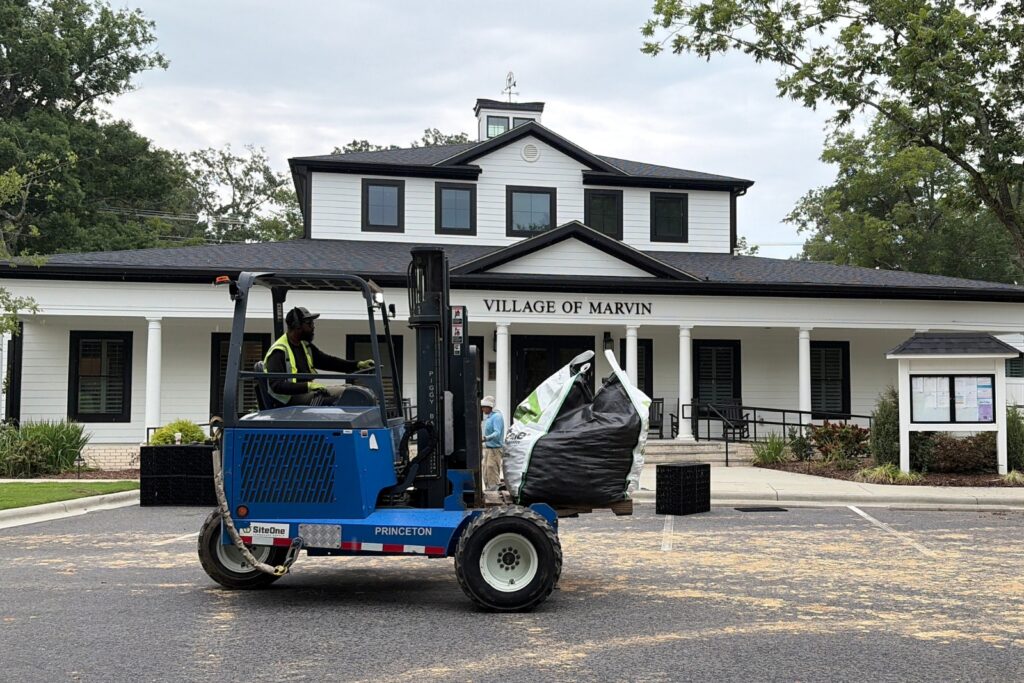 Rocks being delivered in front of Marvin Village Hall for new pond install.