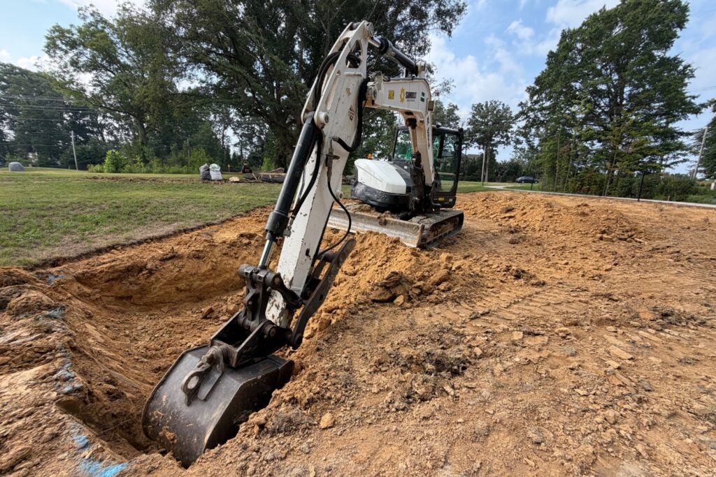 Excavator digging hole for water feature in Marvin, NC.