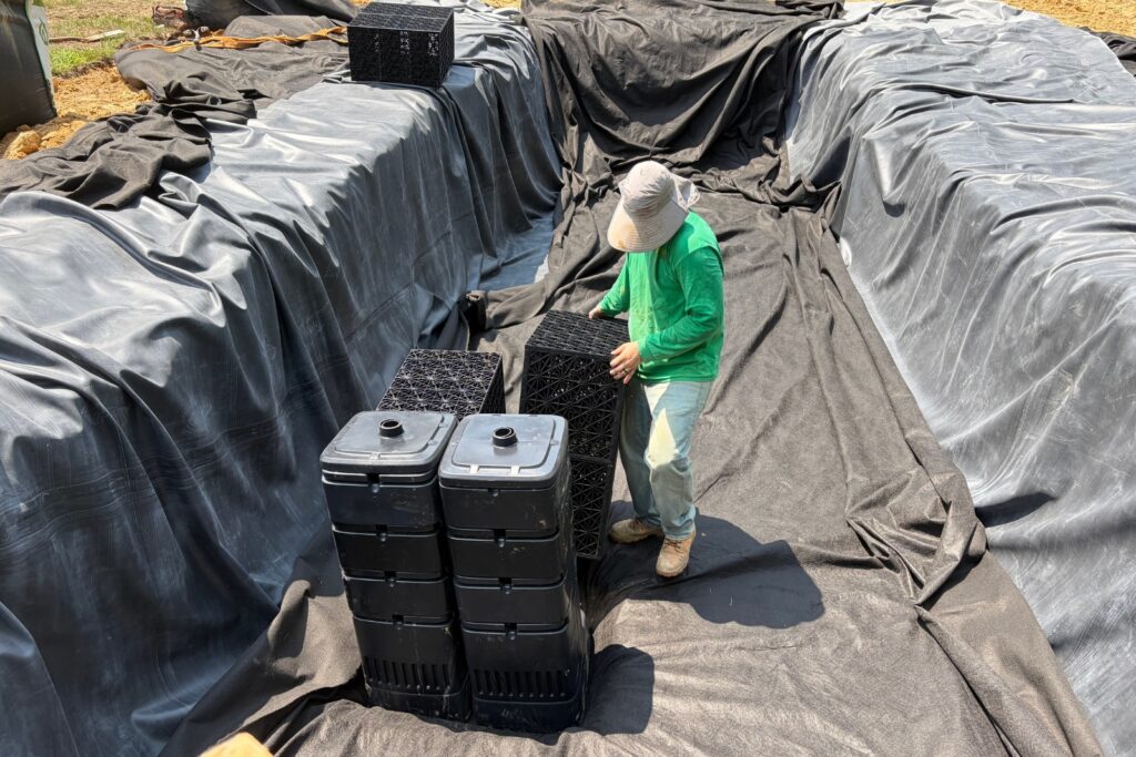 Construction crew placing waterblocks over the liner in newly excavated area in Marvin, NC.