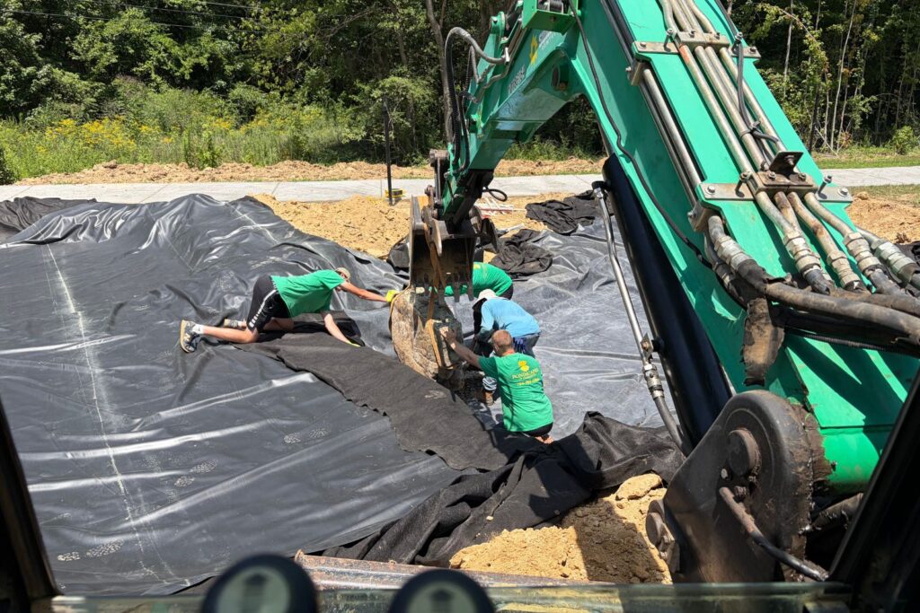 Crew starts positioning boulders for Houston Ross Park new custom water feature.