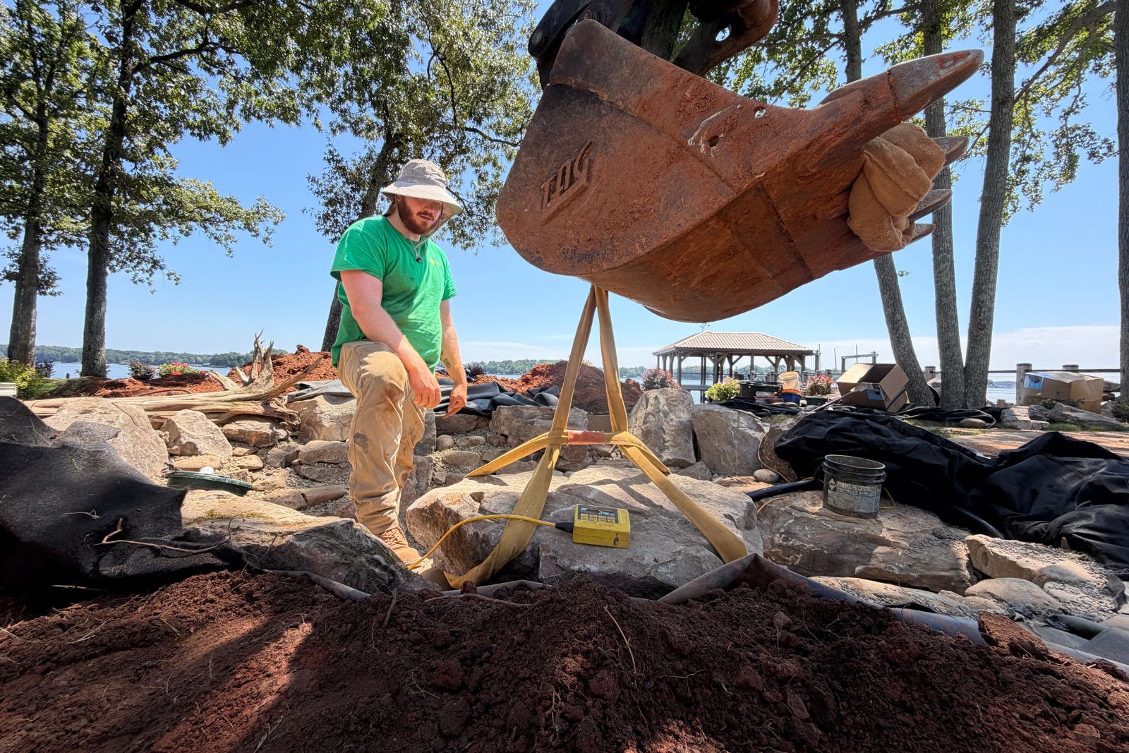 Kieran Boughner setting boulder in pond